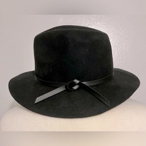 100% wool hat with black faux leather band. Great fall accessory!